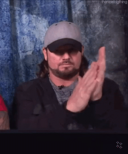 Man in Hat and Jacket Clapping Hands