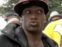 Man in Hat and Jacket Making Face