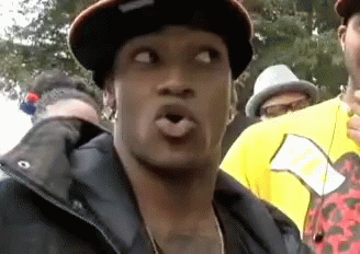 Man in Hat and Jacket Making Funny Face in Crowd