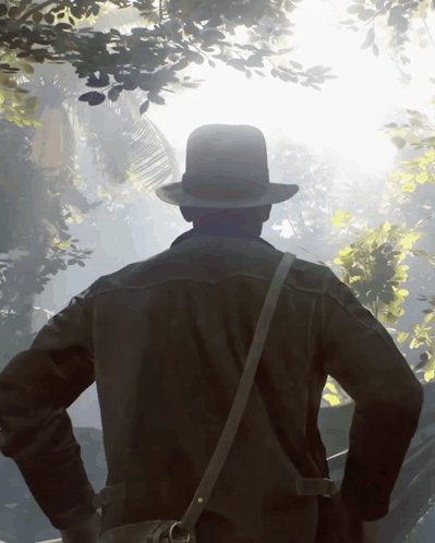 Man in Hat and Leather Jacket Standing in Forest