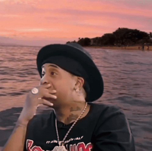 Man In Hat And M T-Shirt Sitting By Water GIF