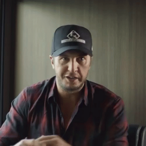 Man in Hat and Plaid Shirt Sitting