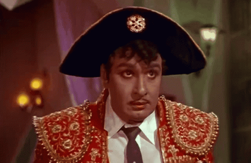 Man in Hat and Red Jacket Looking at Camera