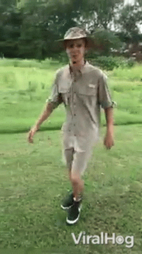 Man In Hat And Shorts Standing On One Leg GIF
