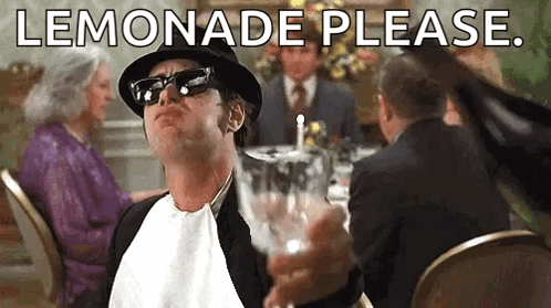 Man In Hat And Sunglasses Holding Lemonade At Table GIF