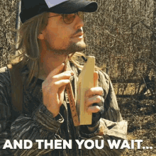 Man in Hat and Sunglasses Holding Wooden Object Saying And Then You Wait