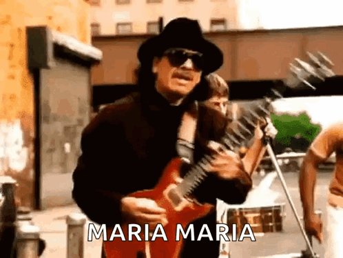 Man in Hat and Sunglasses Playing Guitar on Street