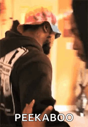 Man in Hat and Sunglasses Says Peekaboo