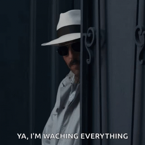 Man in Hat and Sunglasses Says Watching Everything