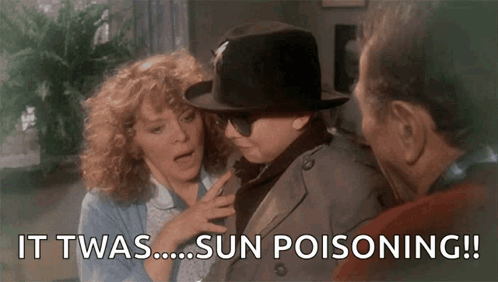 Man in Hat and Sunglasses Talking to Woman and Man in Trench Coat