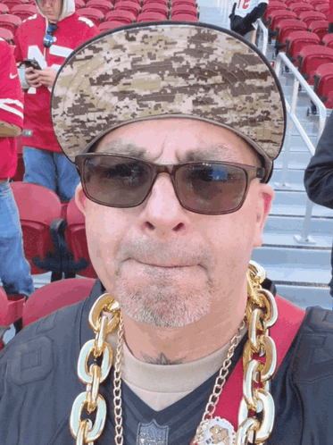 Man in Hat and Sunglasses With 49ers Chain