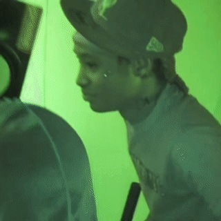 Man In Hat And T-Shirt In Front Of Green Wall GIF