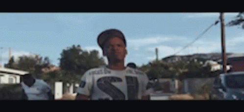 Man In Hat And T-Shirt With Letter S Before Crowd GIF
