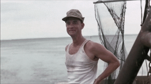 Man in Hat and Tank Top on Boat