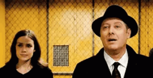 Man In Hat And Tie Next To Woman In Black Shirt GIF