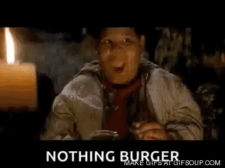 Man in Hat and Tie Sitting By Candle and Nothing Burger Sign