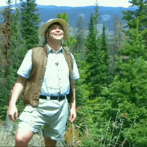 Man in Hat and Vest in Forest