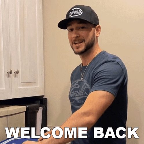 Man in Hat and Welcome Back Shirt