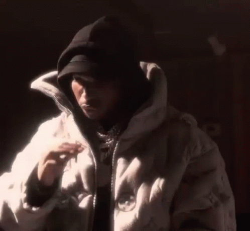 Man in Hat and White Jacket in Dark