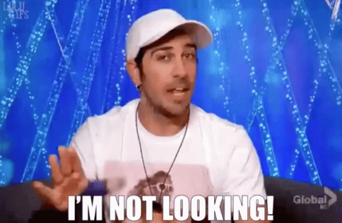 Man in Hat and White Shirt Says I'm Not Looking