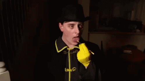 Man in Hat and Yellow Gloves Writing