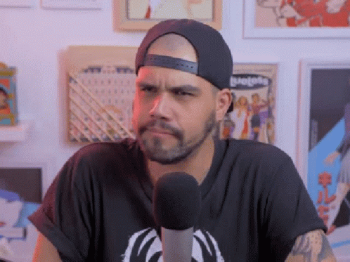 Man In Hat At Microphone Making Funny Face GIF