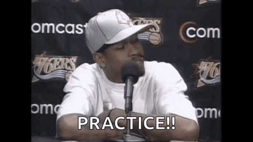 Man in Hat at Microphone Saying Practice!