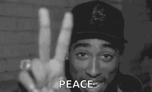 Man in Hat Giving Peace Sign