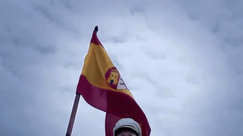 Man in Hat Holding Spanish Flag