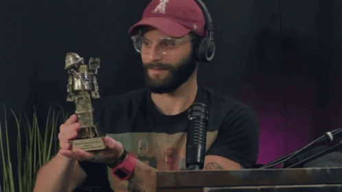 Man in Hat Holding Trophy