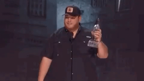 Man In Hat Holding Trophy Giving Middle Finger GIF