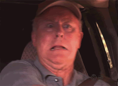 Man in Hat Making Funny Face in Car