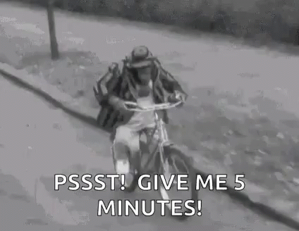 Man in Hat Riding Bicycle
