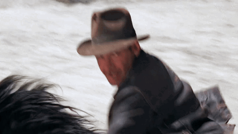 Man in Hat Riding Horse in Snow