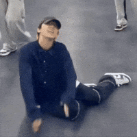 Man in Hat Sitting on Floor
