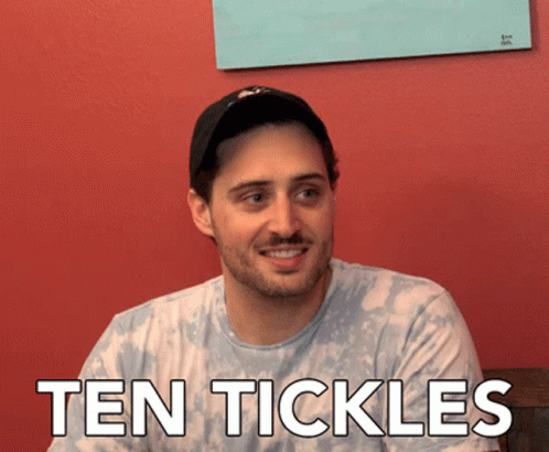 Man in Hat Smiling with Ten Tickles Shirt