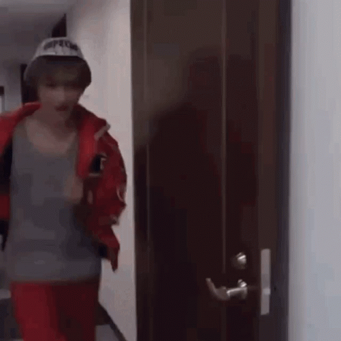 Man in Hat Standing in Front of Door
