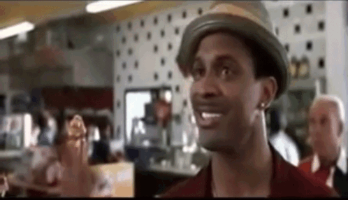Man In Hat Standing In Restaurant GIF
