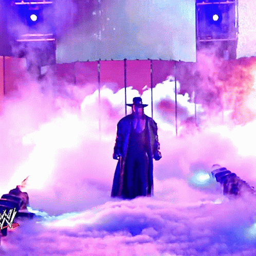 Man in Hat Standing in Smoke
