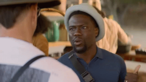 Man In Hat Talking To Another Man In Restaurant GIF