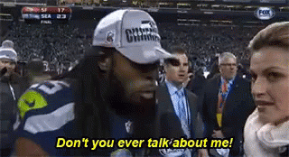Man in Hat Talking to Woman in Crowd