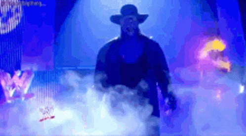 Man in Hat Walking Through Smokey Area With W Logo