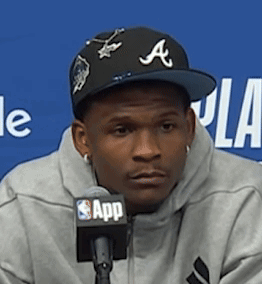 Man in Hat with Letter A at Microphone