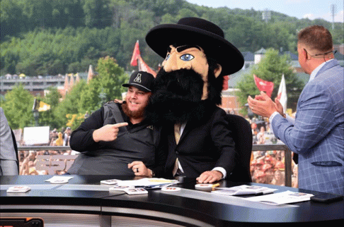 Man In Hat With Letter A Pointing At Mascot GIF