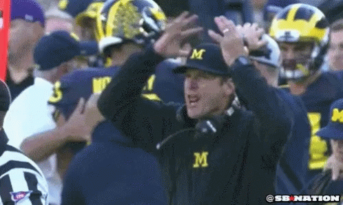 Man in Hat With Letter M in Crowd