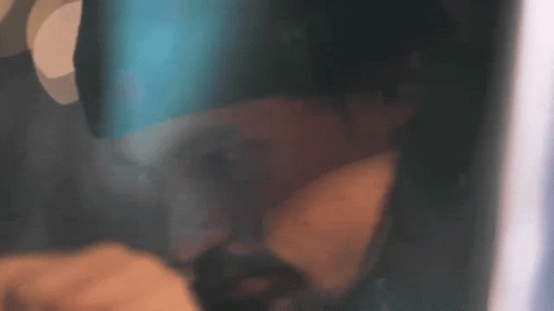 Man in Hat With Letter P Covering Mouth