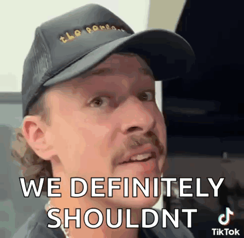 Man in Hat With Mustache Saying We Definitely Shouldn't