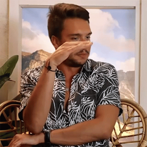 Man In Hawaiian Shirt Covering Nose GIF