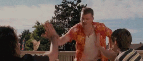 Man in Hawaiian Shirt High-Fiving Group