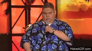 Man in Hawaiian Shirt Holding Microphone Saying Damn